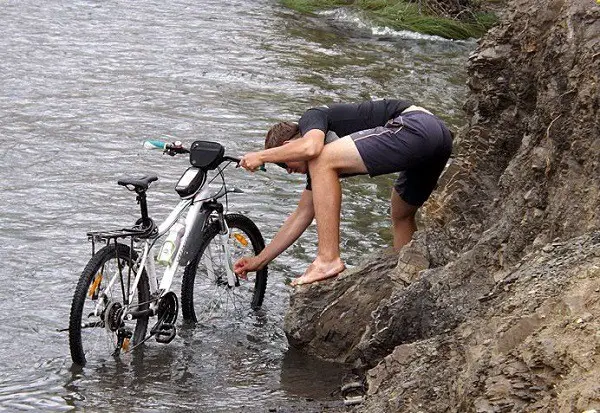washing the bike by the river
